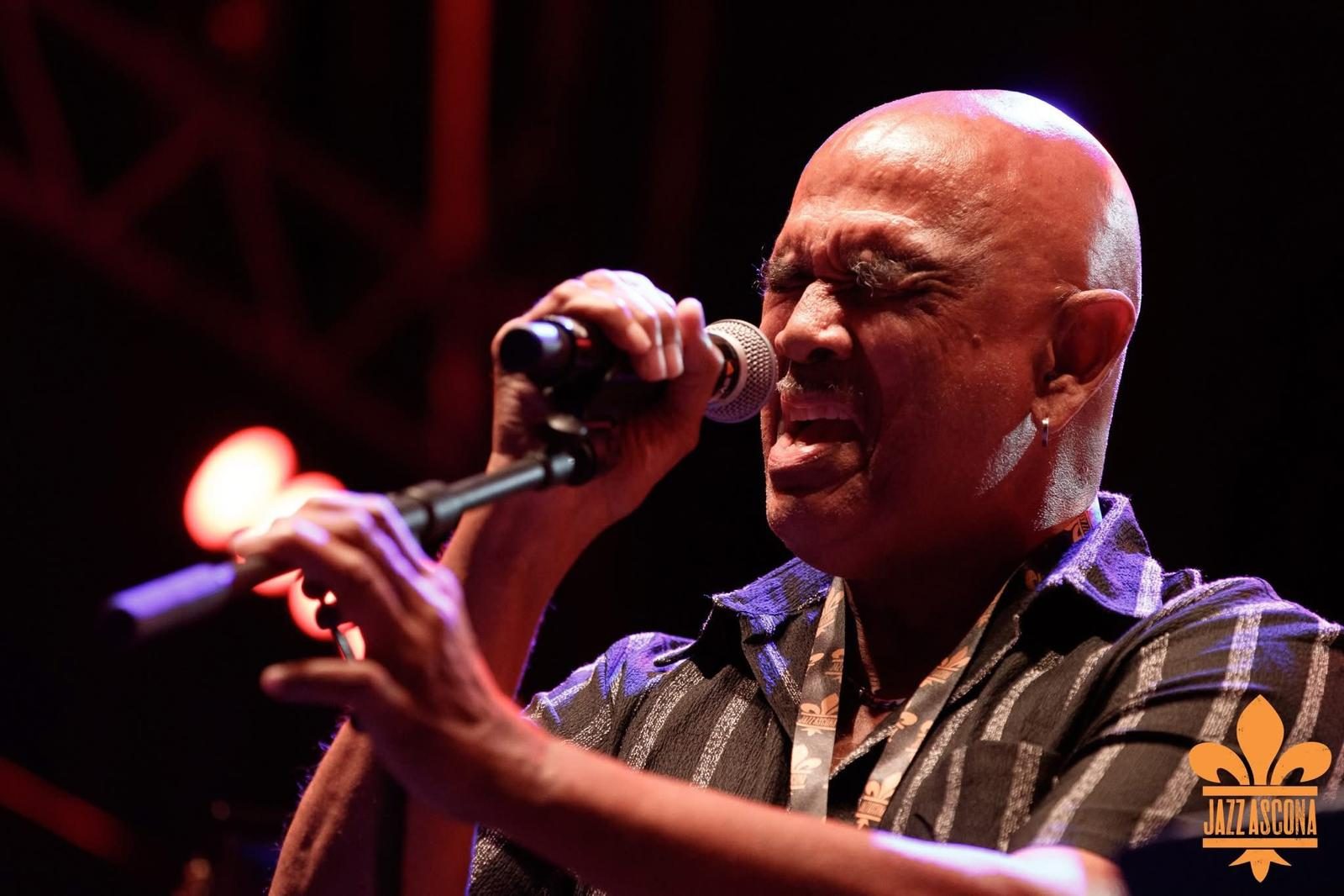 Vocalist singing passionately into a microphone