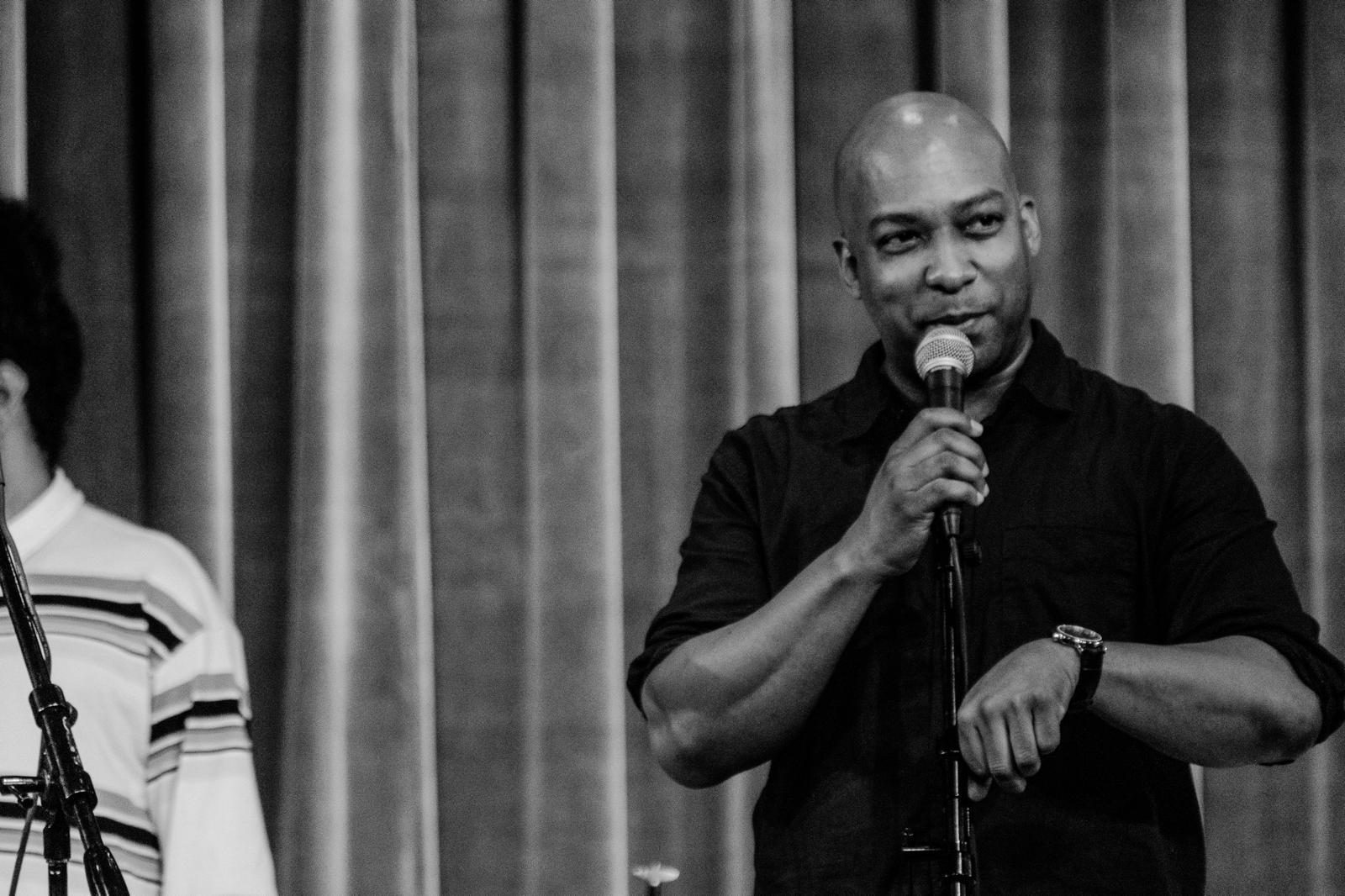 Adonis Rose speaking to an audience from the stage